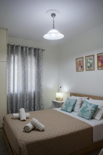 a bedroom with a large bed with towels on it at Helia Apartment 1 in Alepou