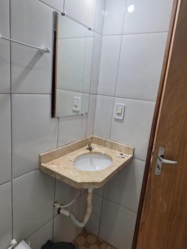 a bathroom with a sink and a mirror at Marcone Lima - Chalés in Barreirinhas