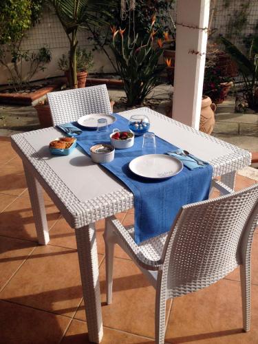 a table with plates and bowls of food on it at B&B Le Vele in Maruggio