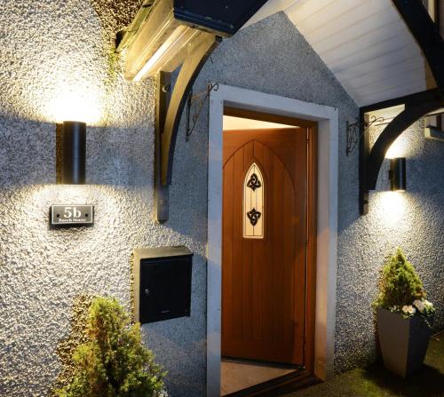 a front door of a house with a sign on it at Beech House in Antrim