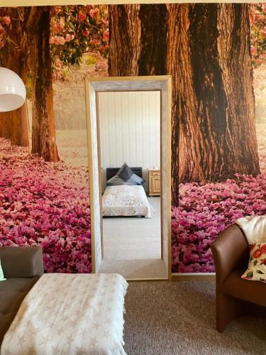 a mirror in front of a bedroom with a tree at Fewo an der Stadtmauer in Quedlinburg