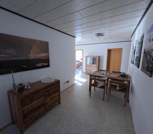 a living room with a desk and a table at FeWo zum Der Hilderser in Hilders