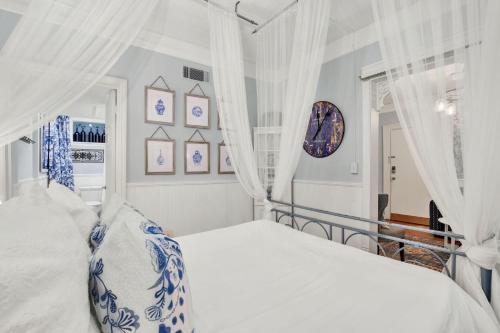 a bedroom with a bed with blue and white pillows at Haint & Porcelain in Savannah