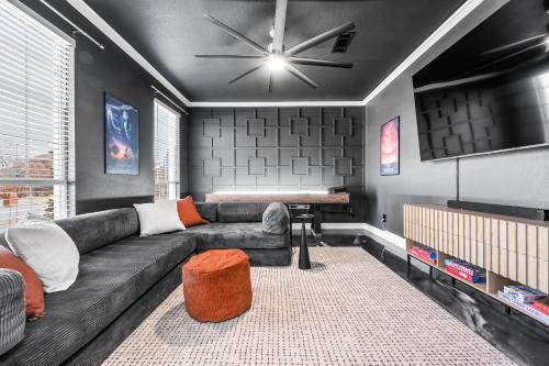 a living room with a couch and a piano at Elegant 5BR Pool House with Cinema Fire Pit and Games in Keller