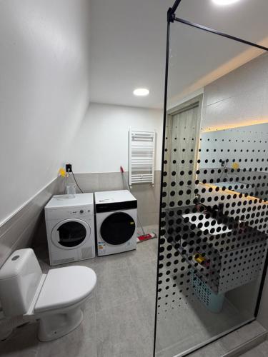 a bathroom with a microwave and a toilet at Take A Brake Kazbegi Cottage in Kazbegi