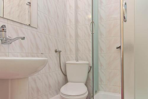 a bathroom with a toilet and a sink and a shower at Willa Irena in Karwia