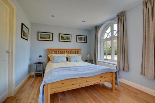 a bedroom with a large bed and a window at 1 Bed in Northrepps oc-1736 in Northrepps