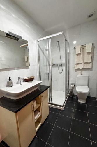 a bathroom with a shower and a sink and a toilet at Casa do Olival in Macedo de Cavaleiros