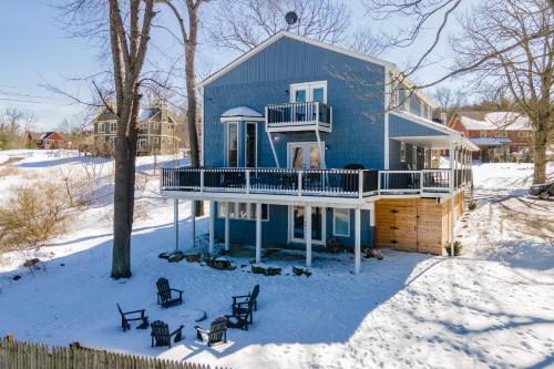 a blue house with a deck in the snow at Blue Skies by Railey Vacations in Oakland