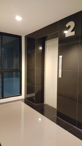 a bathroom with black and white walls and a window at The Pixel Places in Nonthaburi