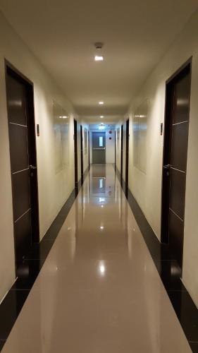 an empty hallway of a building with doors and ceilings at The Pixel Places in Nonthaburi