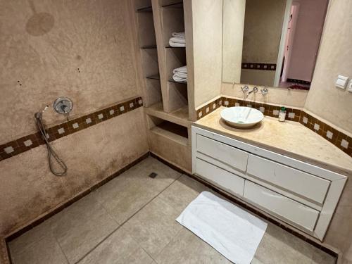 a bathroom with a sink and a mirror at Al ATLAS résidence in Marrakesh