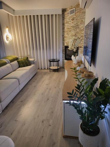 a living room with a couch and a table at Casa do Azeite in Torre de Moncorvo