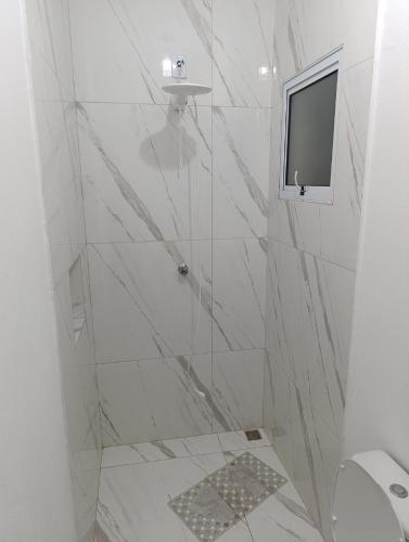 a bathroom with a shower with a television in it at Chácara Paraíso in Itupeva