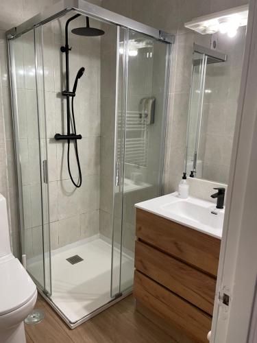 a bathroom with a shower and a sink at Apartamento Comillas Beach in Comillas