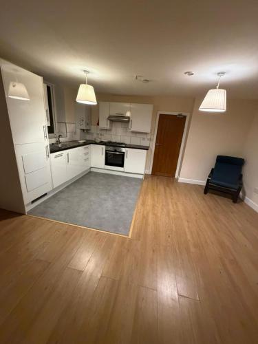an empty room with a kitchen and a living room at OYO Royal Lodge Maidstone in Maidstone
