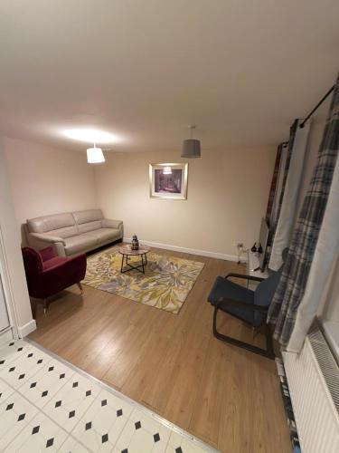 a living room with a couch and a table at OYO Royal Lodge Maidstone in Maidstone