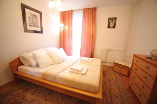 a bedroom with a bed with two towels on it at Apartament Tais in Wrocław