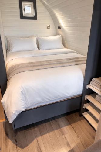 two beds in a tiny house with a staircase at Millfield Glamping Pods - Heatherhouse in Orkney