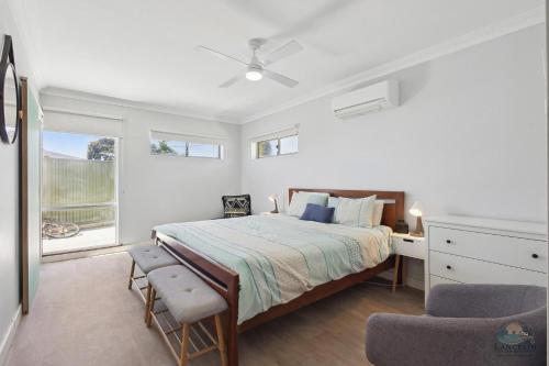 a bedroom with a bed and a desk and a chair at Sea Chain in Lancelin