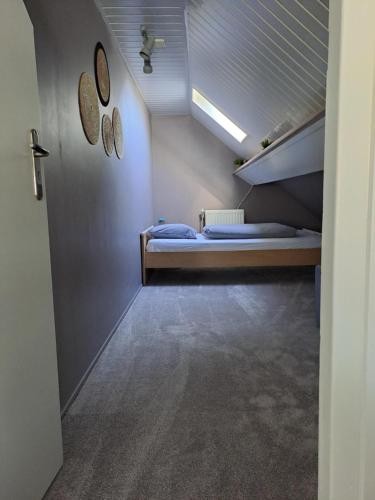 a bedroom with a bunk bed in a attic at Vakantiehuis in Oosterwolde