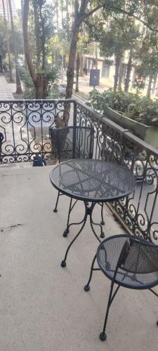 a table and chairs next to a wrought iron fence at Hostel Hostel in Batumi