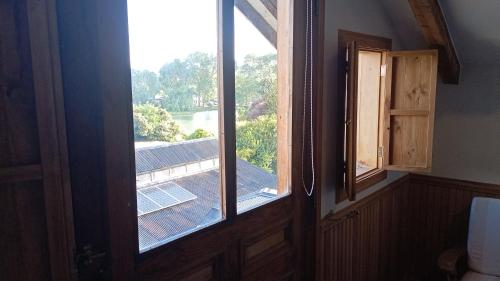 a window in a room with a view of a roof at Hotel Boutique Casa Werner in Puerto Varas