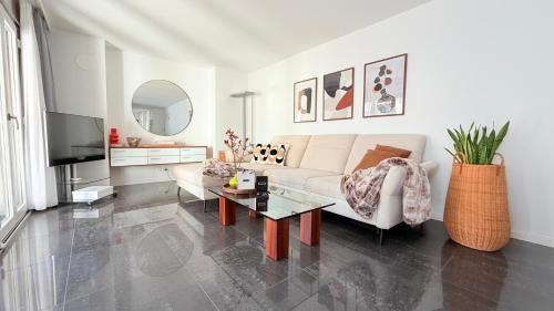 a living room with a couch and a table at Center Park Apartment in Interlaken