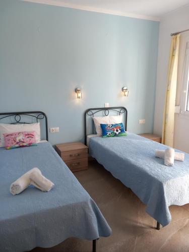 two beds in a bedroom with towels on them at Thalassoudis-House 2 in Agios Nikolaos