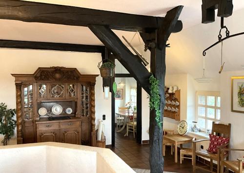 a kitchen and dining room with wooden beams at Haus Birkenhof in Moorhausen