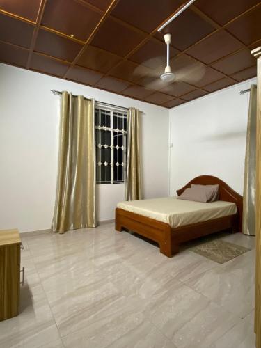 a bedroom with a bed and a window at Coastal Retreat Penthouse in Pereybere
