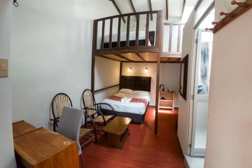 a bedroom with a bunk bed and a staircase at Cusco'sHome 3 in Cusco