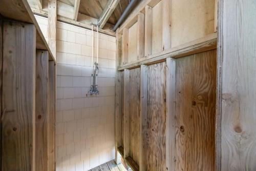 a bathroom with wooden walls and a tiled wall at Atlantic Watch in Kill Devil Hills