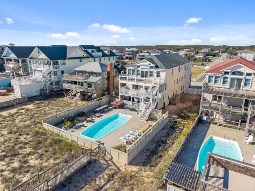 an aerial view of a pool and buildings at Atlantic Watch in Kill Devil Hills
