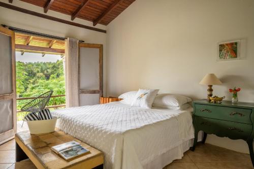 a bedroom with a white bed and a window at Jardim da Amazônia Lodge in Sao Jose do Rio Claro