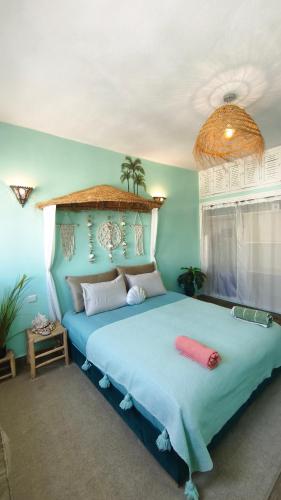 a bedroom with a large bed with a blue bedspread at Premium Flat Agadir - Immersive rental --- Maison Bleue --- Fast wifi in Agadir
