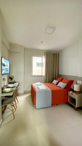 a bedroom with a red bed and a desk and a computer at Dom Carlos in Belém