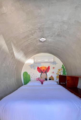 a bedroom with a bed in a tunnel at ChangoMango in La Ventana