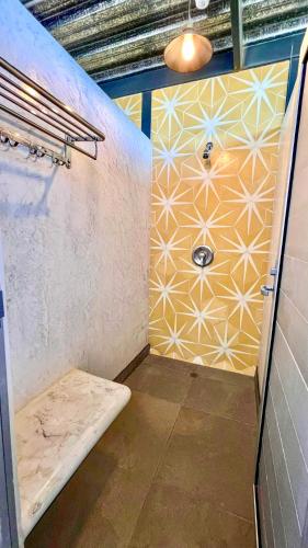 a bathroom with a shower with a bench in it at ChangoMango in La Ventana