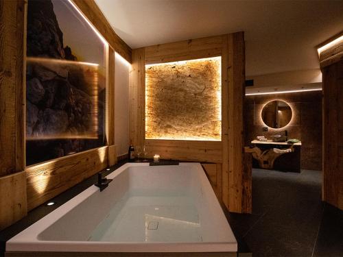 a large bath tub in a room with a window at SKY LOVE Luxury Chalet in Andalo