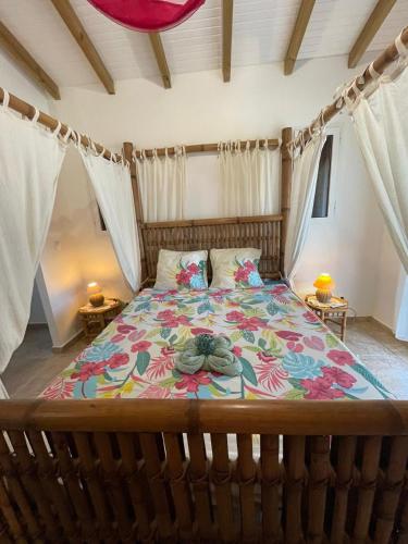 a bedroom with a large bed with a colorful bedspread at Le Chalet des Rêves Ensoleillés in Saint-François