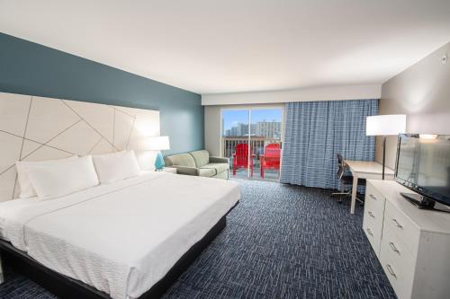 a hotel room with a bed and a desk and a television at Bonita Beach Hotel in Ocean City