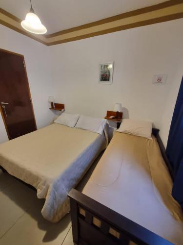 two beds sitting in a room with at Espacio Verde in Salta