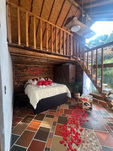 a bedroom with a bed with red roses on the floor at Chalet del lago Santa Elena in Santa Elena