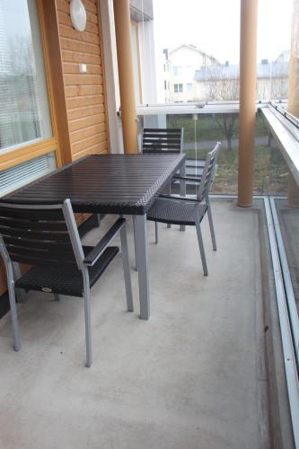 a black table and chairs on a patio at Apartment Nallisuites in Oulu