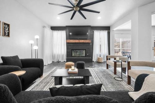 a living room with a couch and a fireplace at Elegant 5BR Pool House with Cinema Fire Pit and Games in Keller