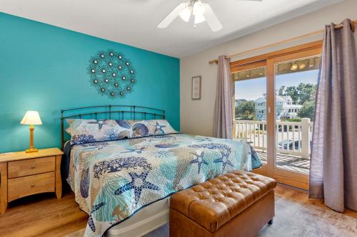 a bedroom with a bed with a blue wall at Anchors Away in Corolla