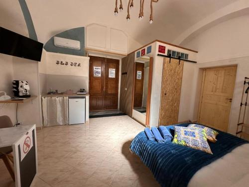 a kitchen with a bed in the middle of a room at Dea in Maddaloni