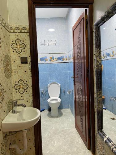 a bathroom with a toilet and a sink at maison de bonheur 2 in Tafraout
