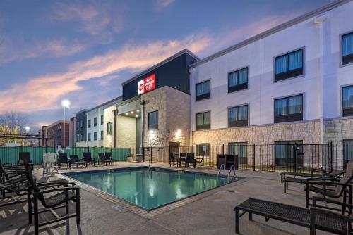 a hotel with a pool in front of a building at Best Western Plus Austin Airport Inn & Suites in Austin
